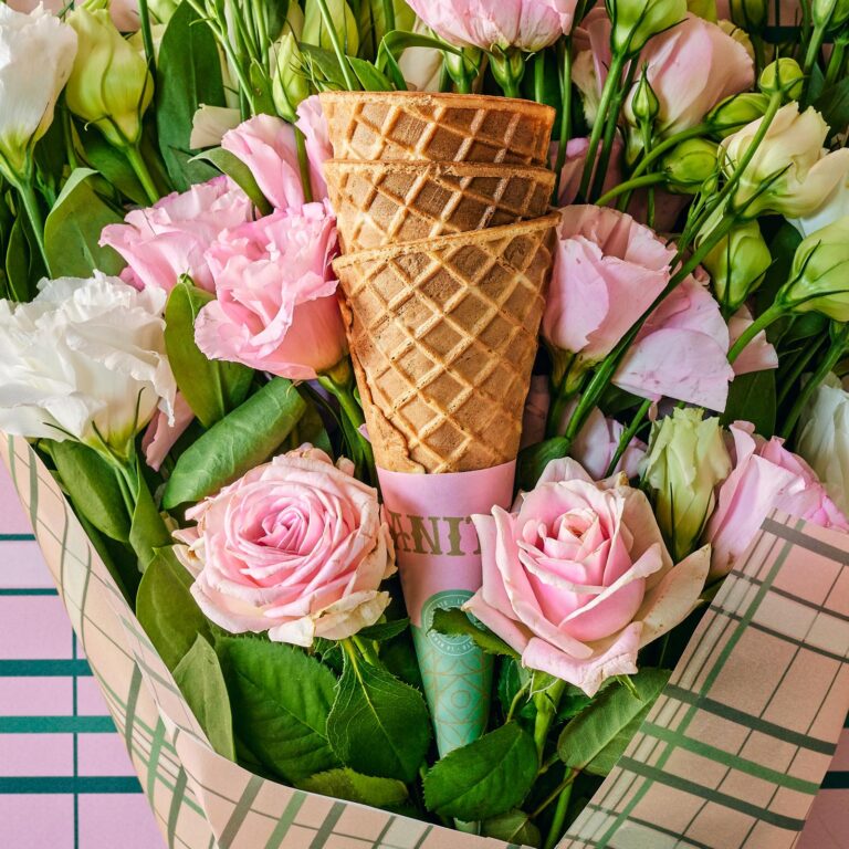 there is a bouquet of flowers with a cone in it