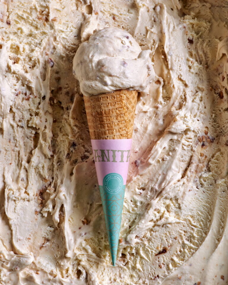 An ice cream cone with a waffle cone sticking out, showcasing a delicious frozen treat.