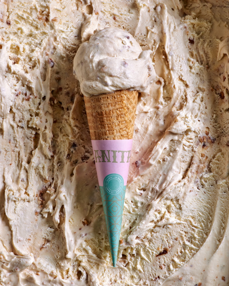An ice cream cone with a waffle cone sticking out, showcasing a delicious frozen treat.