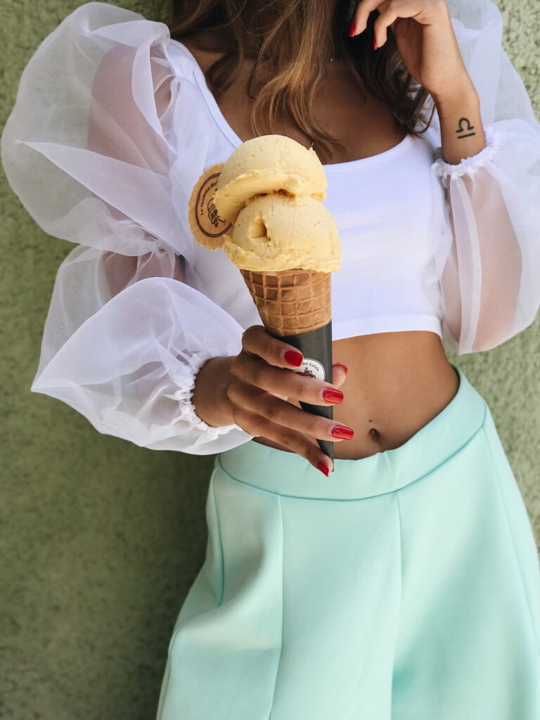 Woman holding ice cream cone.