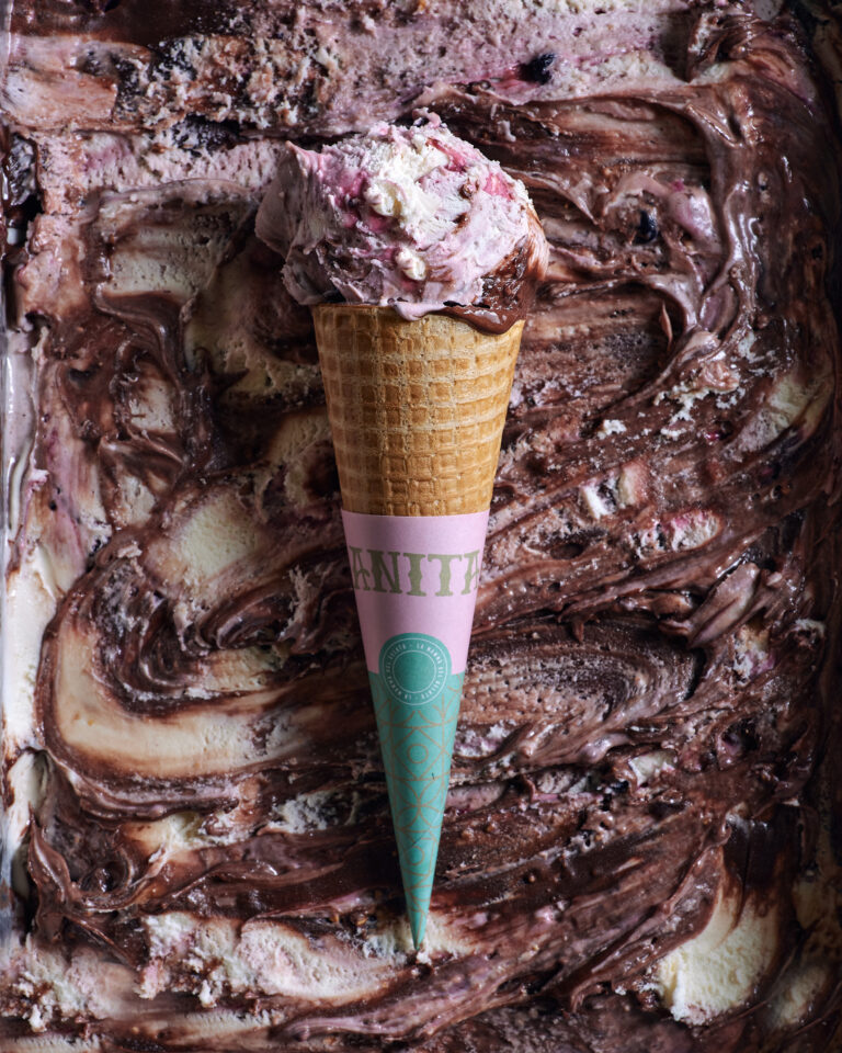 there is a chocolate ice cream cone with a pink and green cone