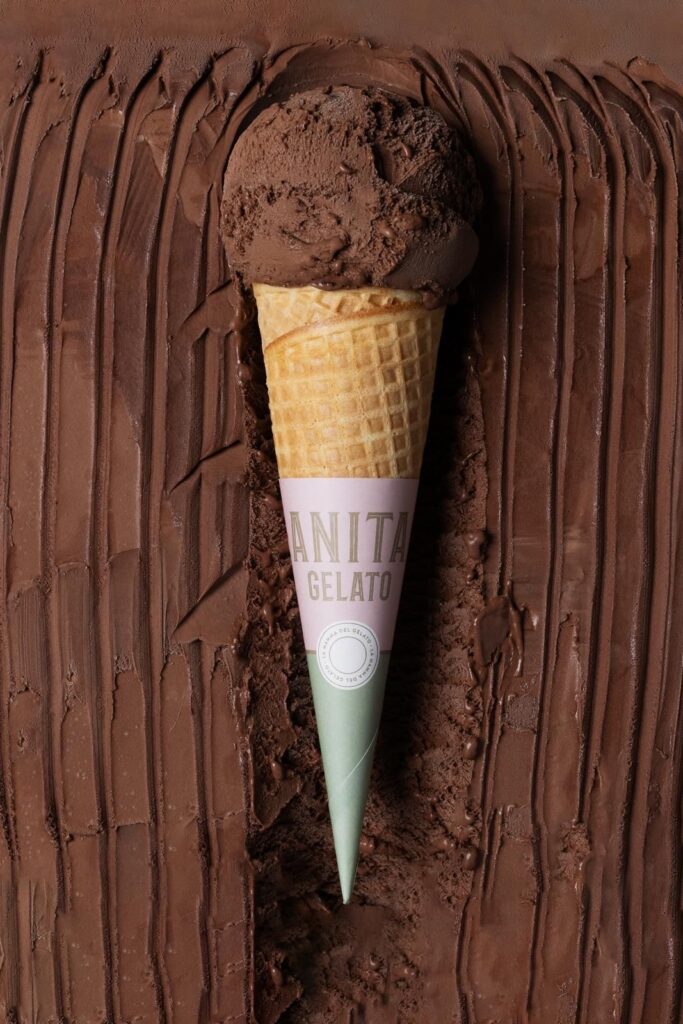there is a chocolate ice cream cone sticking out of a chocolate cake