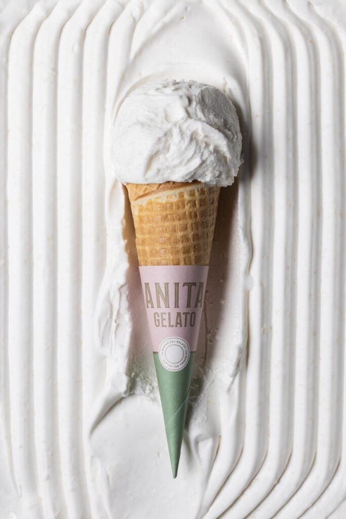 there is a cone of ice cream on a cake with icing
