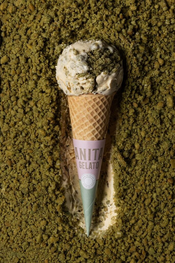 there is a scoop of ice cream in a cone on a bed of green grass