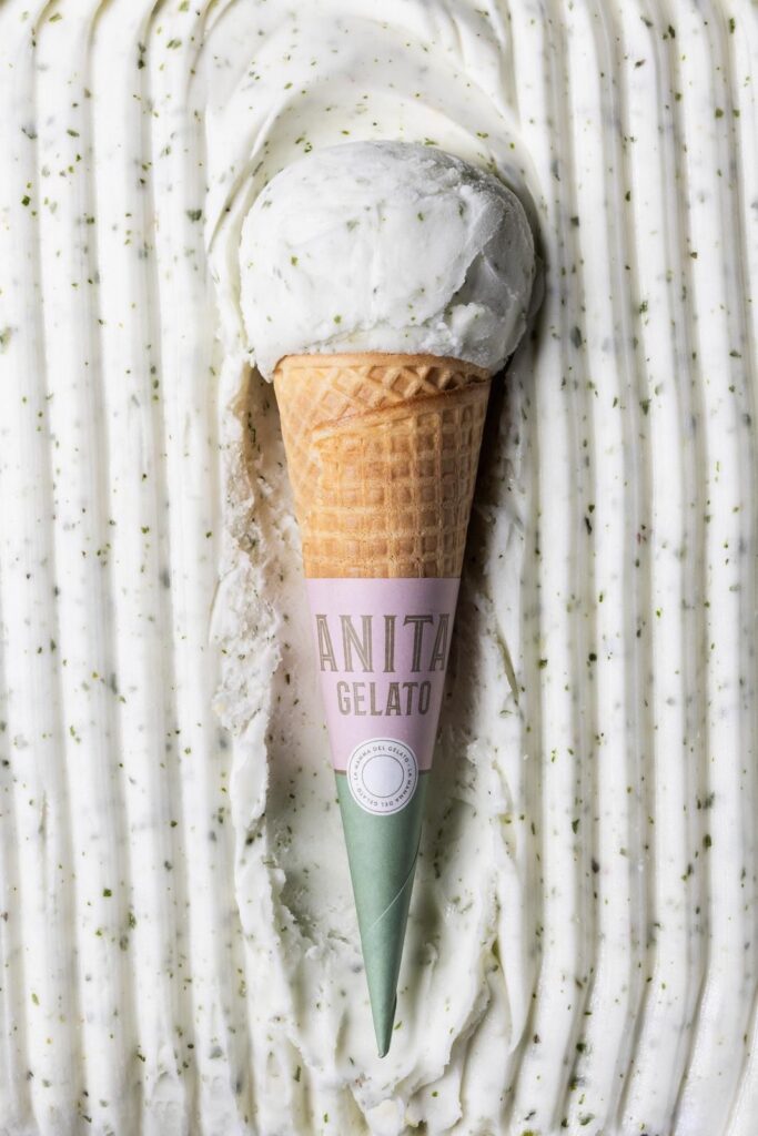 there is a ice cream cone with a green cone sticking out of it