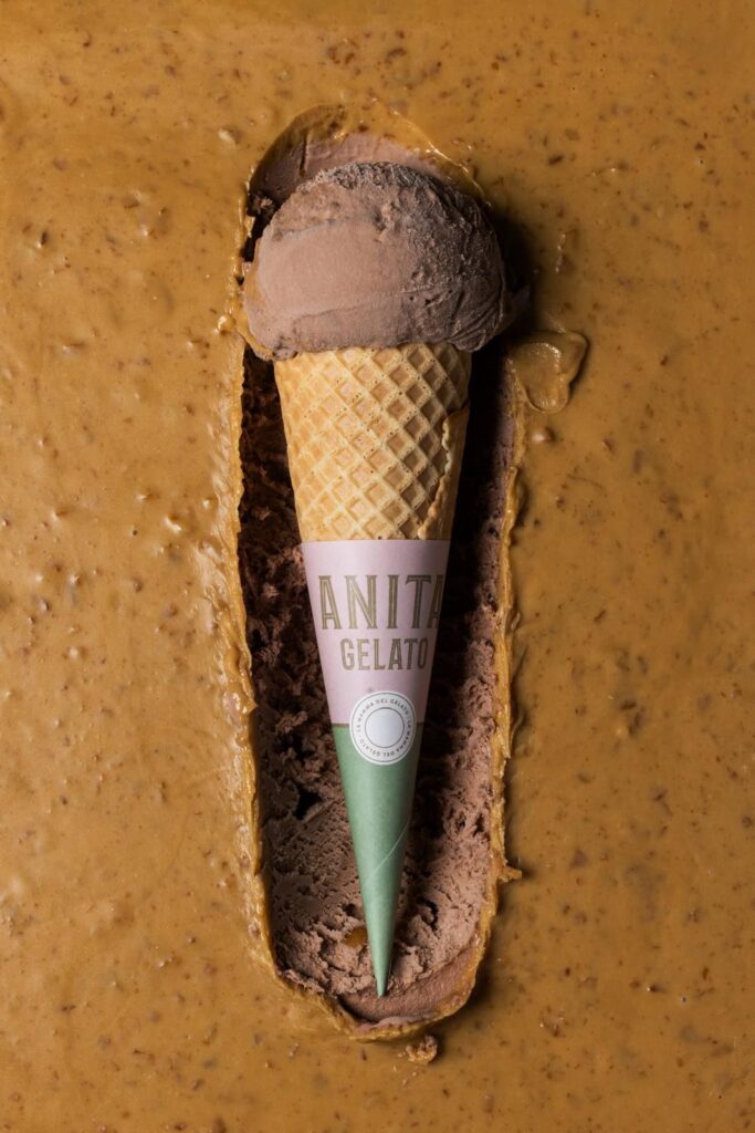 there is a chocolate ice cream cone with a green cone sticking out of it