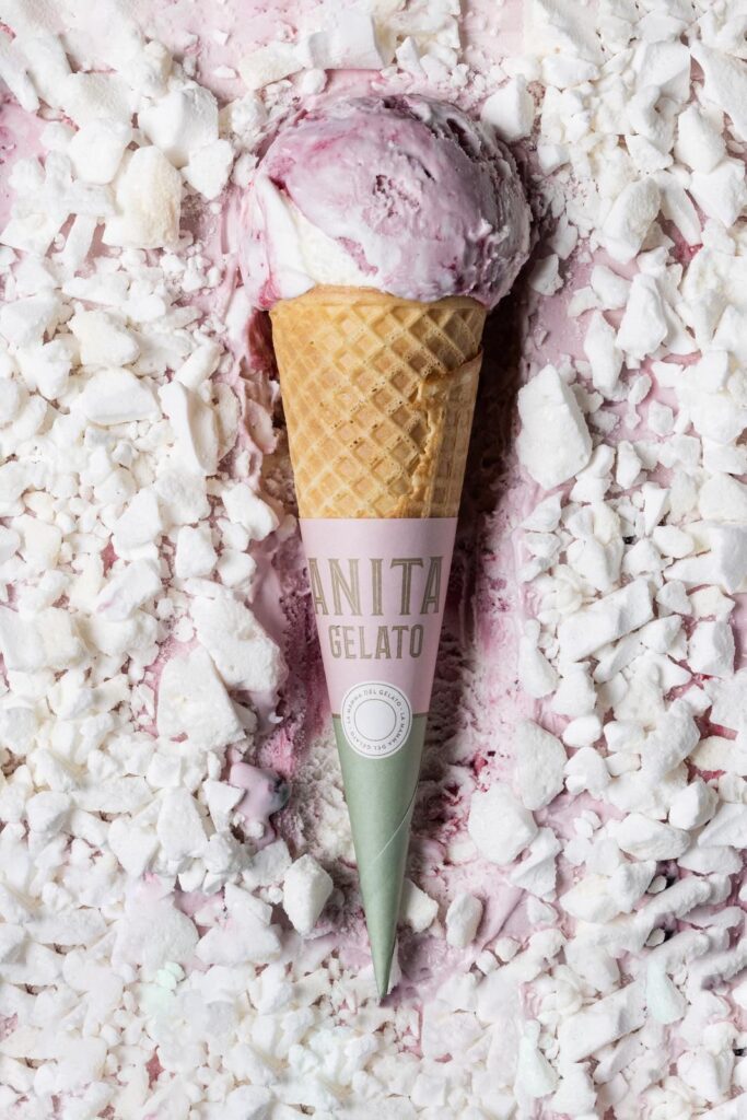 there is a pink ice cream cone with a green cone on top