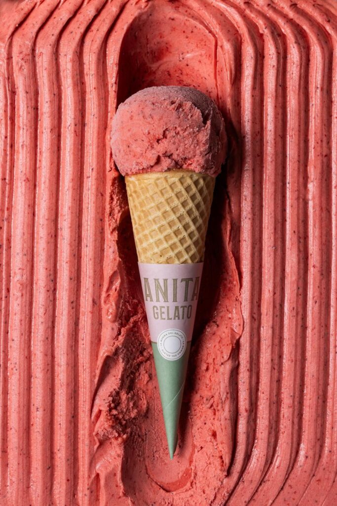 there is a pink ice cream cone with a green cone sticking out of it