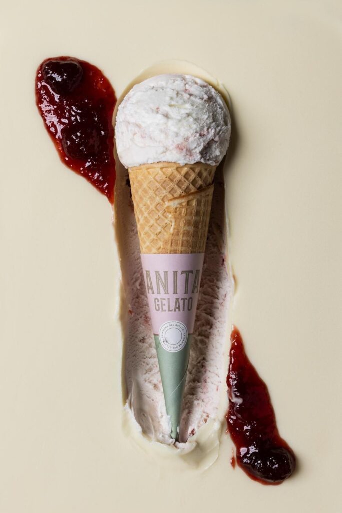 there is a ice cream cone with a strawberry on top