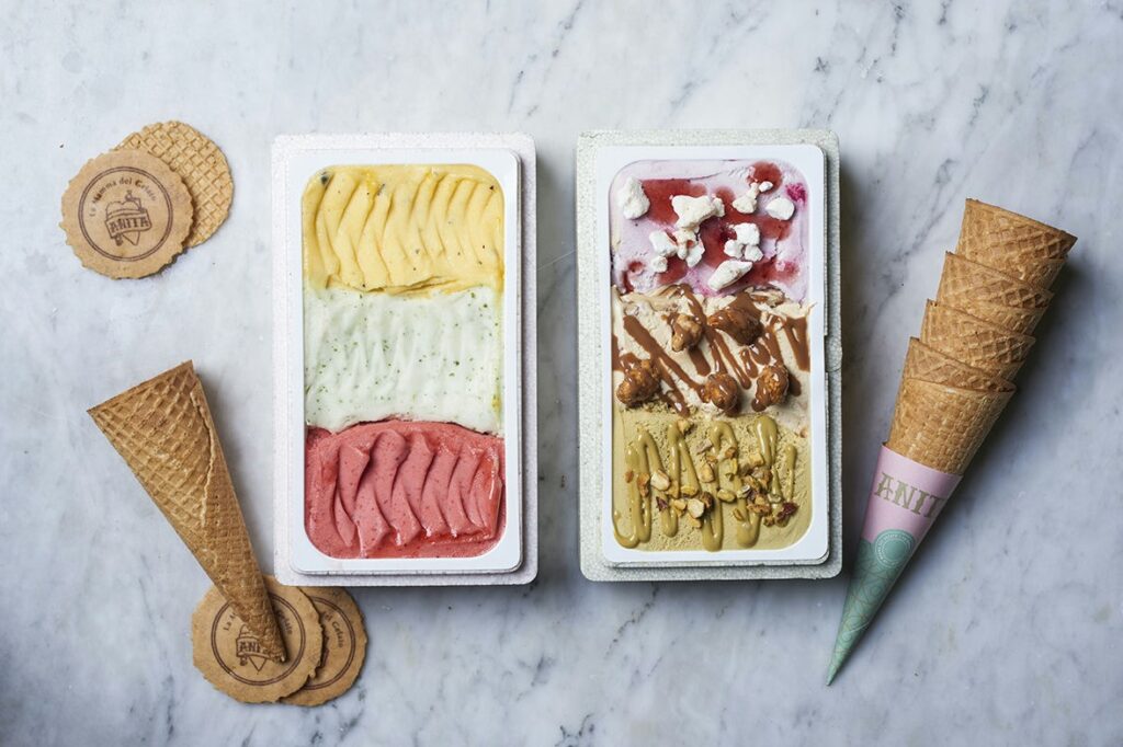 two ice creams in containers with a scoop of ice cream