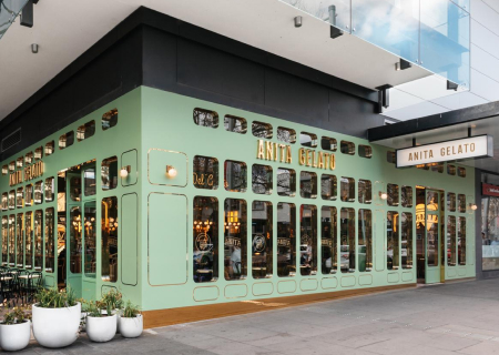there is a green building with a sign that says the art of beer