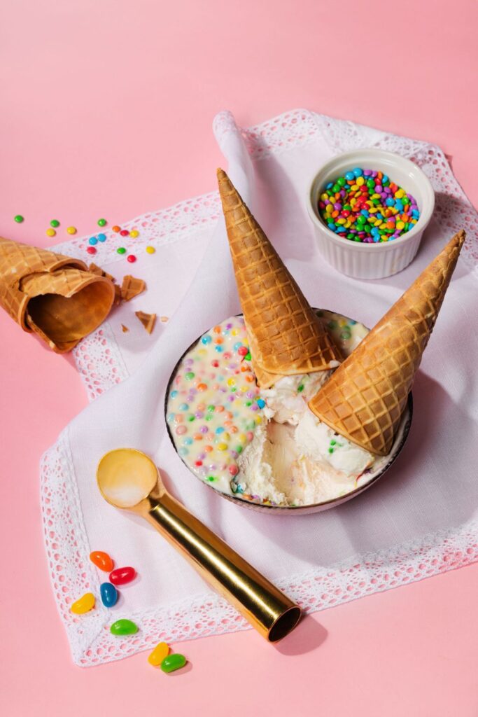 there is a bowl of ice cream with sprinkles and a spoon