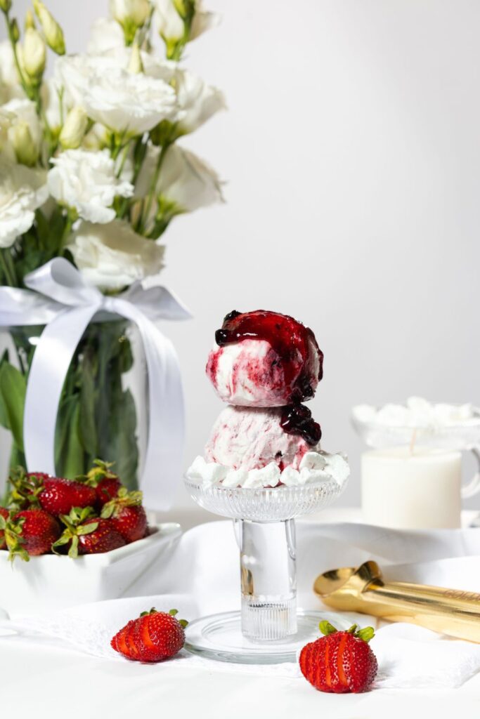 there is a dessert with strawberries and ice cream on a plate