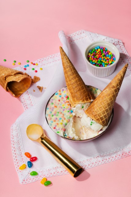 there is a bowl of ice cream with sprinkles and a spoon