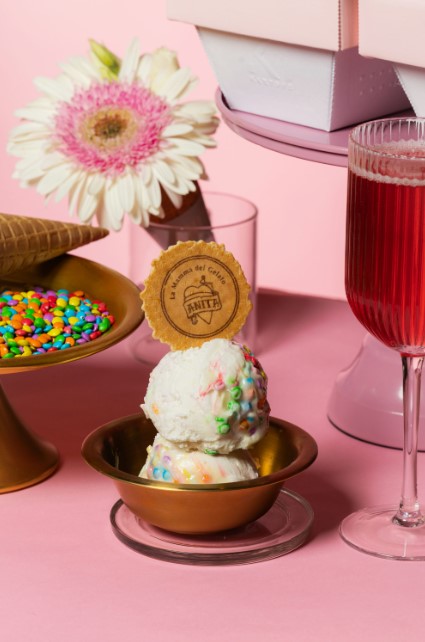 there is a glass of wine and a plate of ice cream