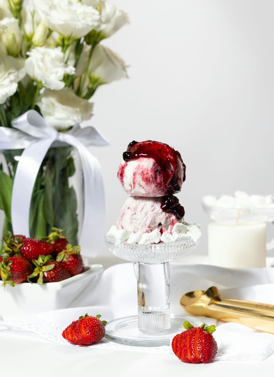 there is a dessert with strawberries and whipped cream on a plate