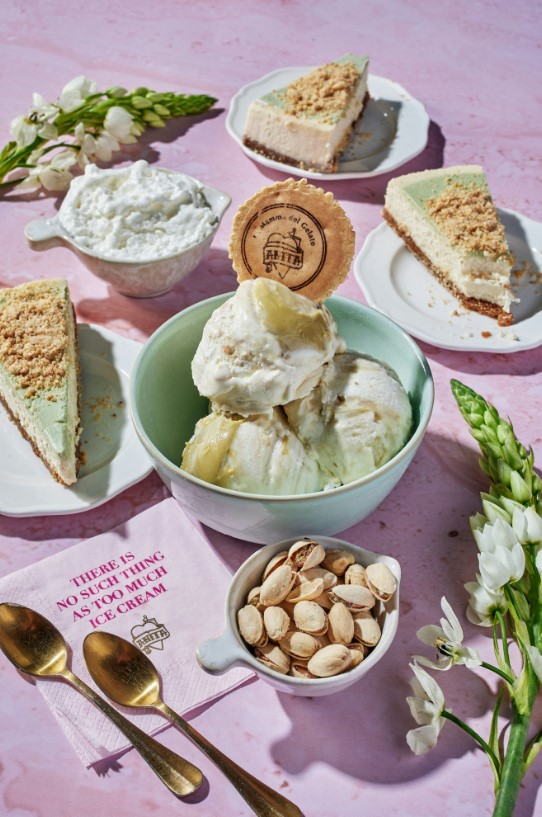 there are many different desserts on the table with a pink background