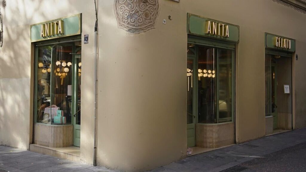 there is a store front with a clock on the wall