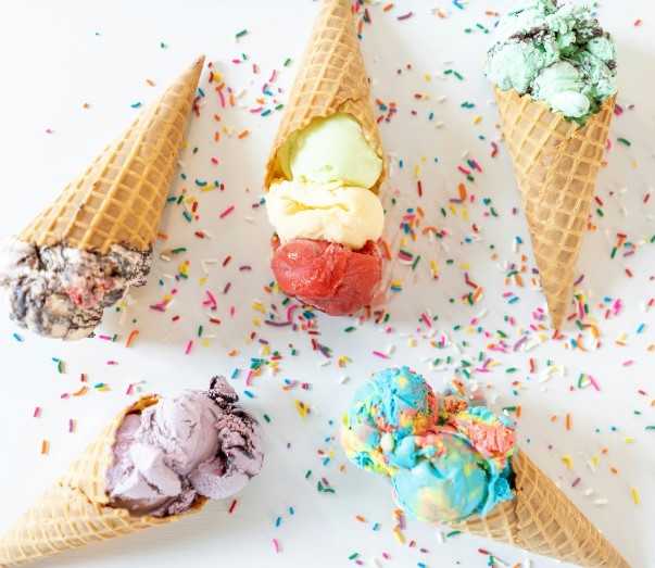 a close up of a group of ice cream cones with sprinkles