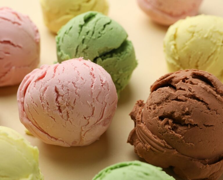 a close up of a group of different colored ice creams