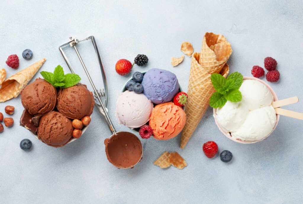 there are many different ice creams in bowls and spoons