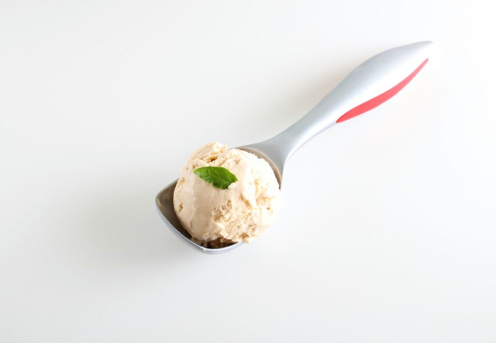 there is a scoop of ice cream with a leaf on it