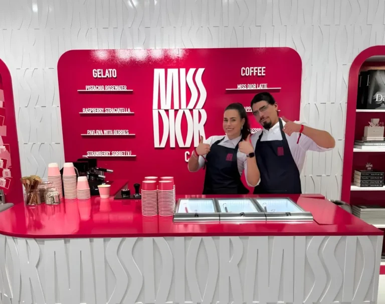 arafed man and woman standing behind a counter in a store