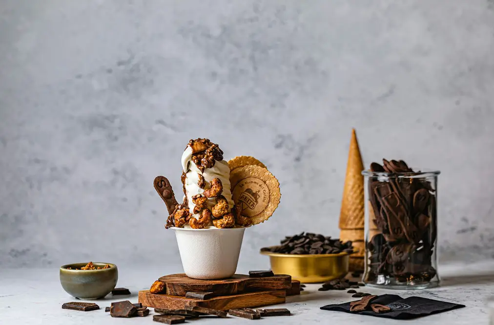 a close up of a cup of ice cream with a scoop of ice cream