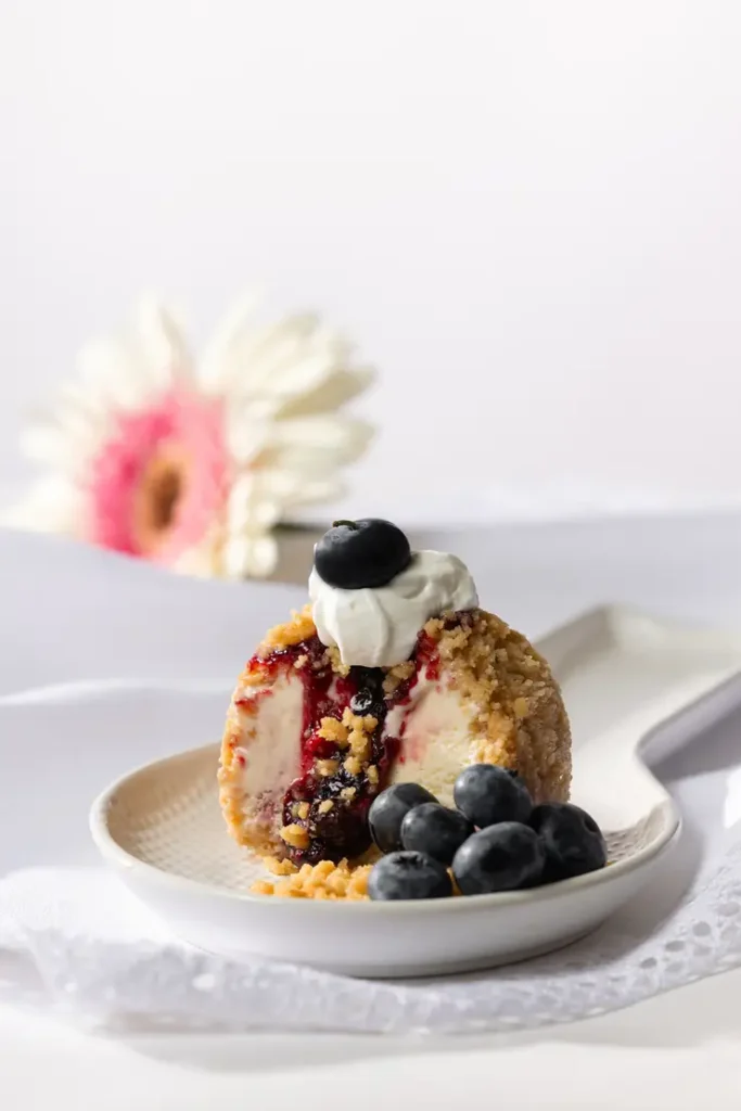 there is a piece of cake with blueberries and whipped cream on it