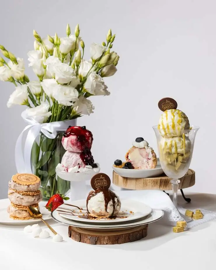 there are a bunch of desserts on a table with flowers